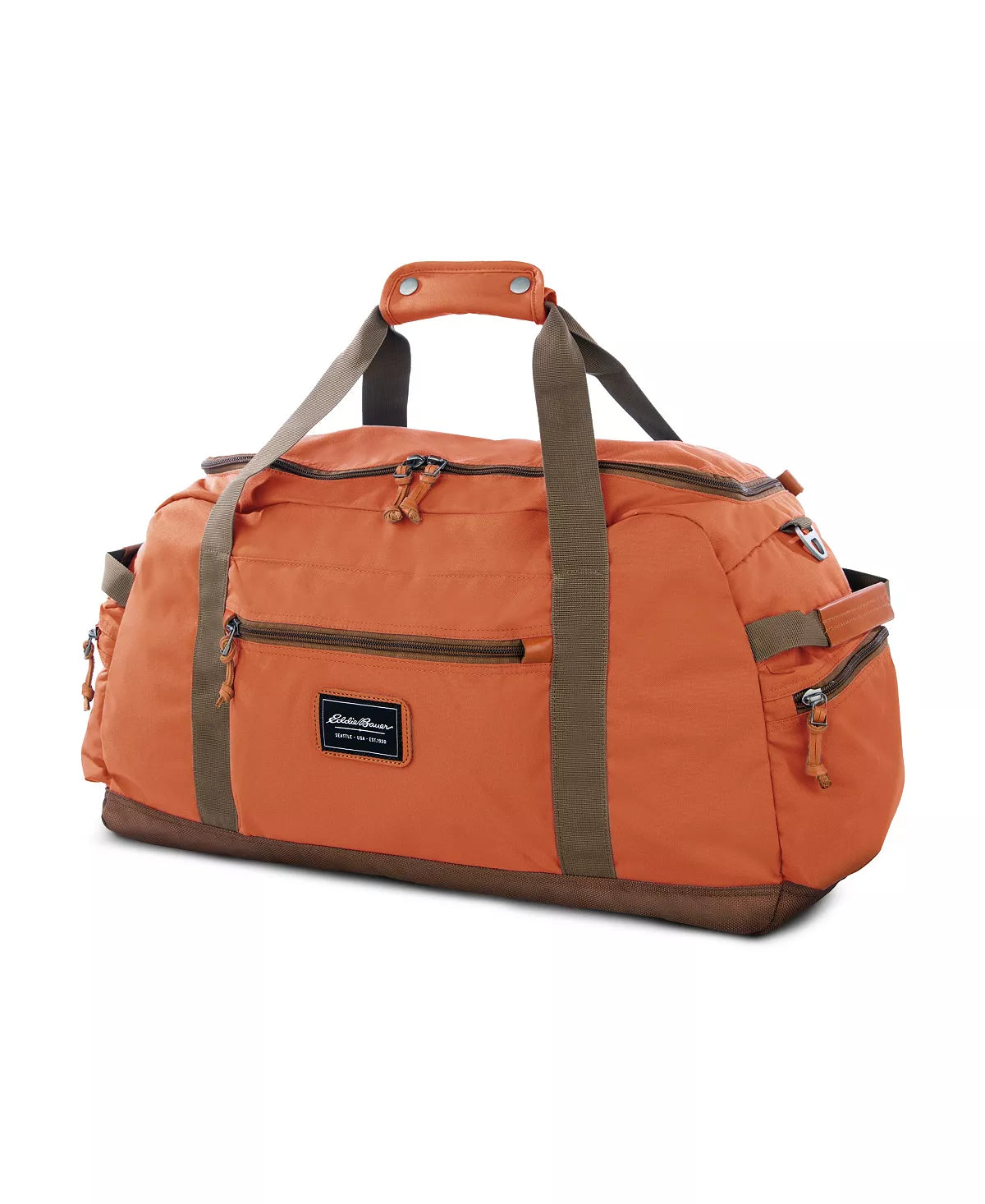 The Eddie Bauer Bygone Recycled 45L Duffel in Terracotta, made from recycled nylon, boasts an orange color with brown straps and multiple zip compartments. A rectangular label accents the front against a white background.