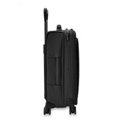 The Briggs & Riley Baseline Essential 22 Carry-On Expandable Spinner in black features a sleek side view with an extended telescopic handle, visible wheels, side zippered compartments, and a garment folder, all set against a white background.