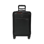 The Briggs & Riley Baseline Essential 22 Carry-On soft sided suitcase with four wheels and a retractable handle, featuring a front zipper pocket, luggage tag, and CX expansion for added space.