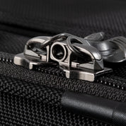 Ricardo Flight Essentials Softside Carry-On - Black, Close-up of a zipper with interlocking metal pullers, designed for a TSA lock.